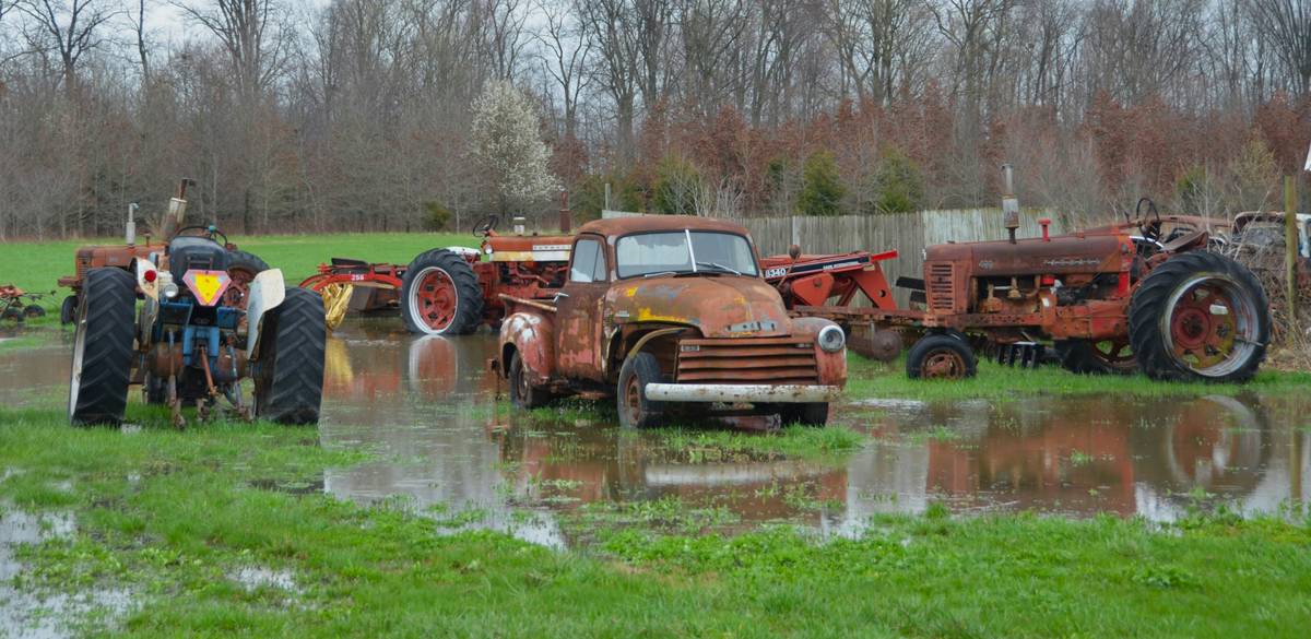Person signing an insurance form at a desk with papers spread out